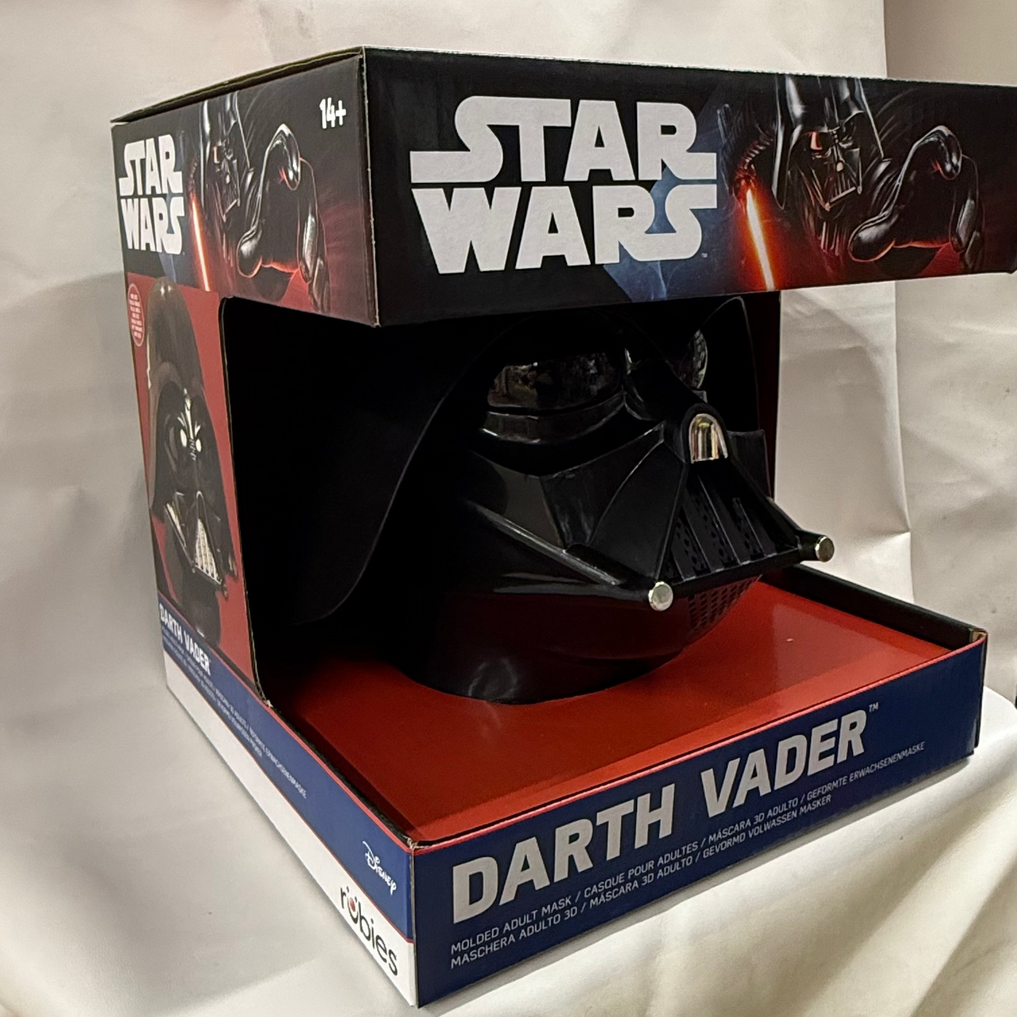 Darth Vader helmet in a 'Star Wars' branded box on a white background