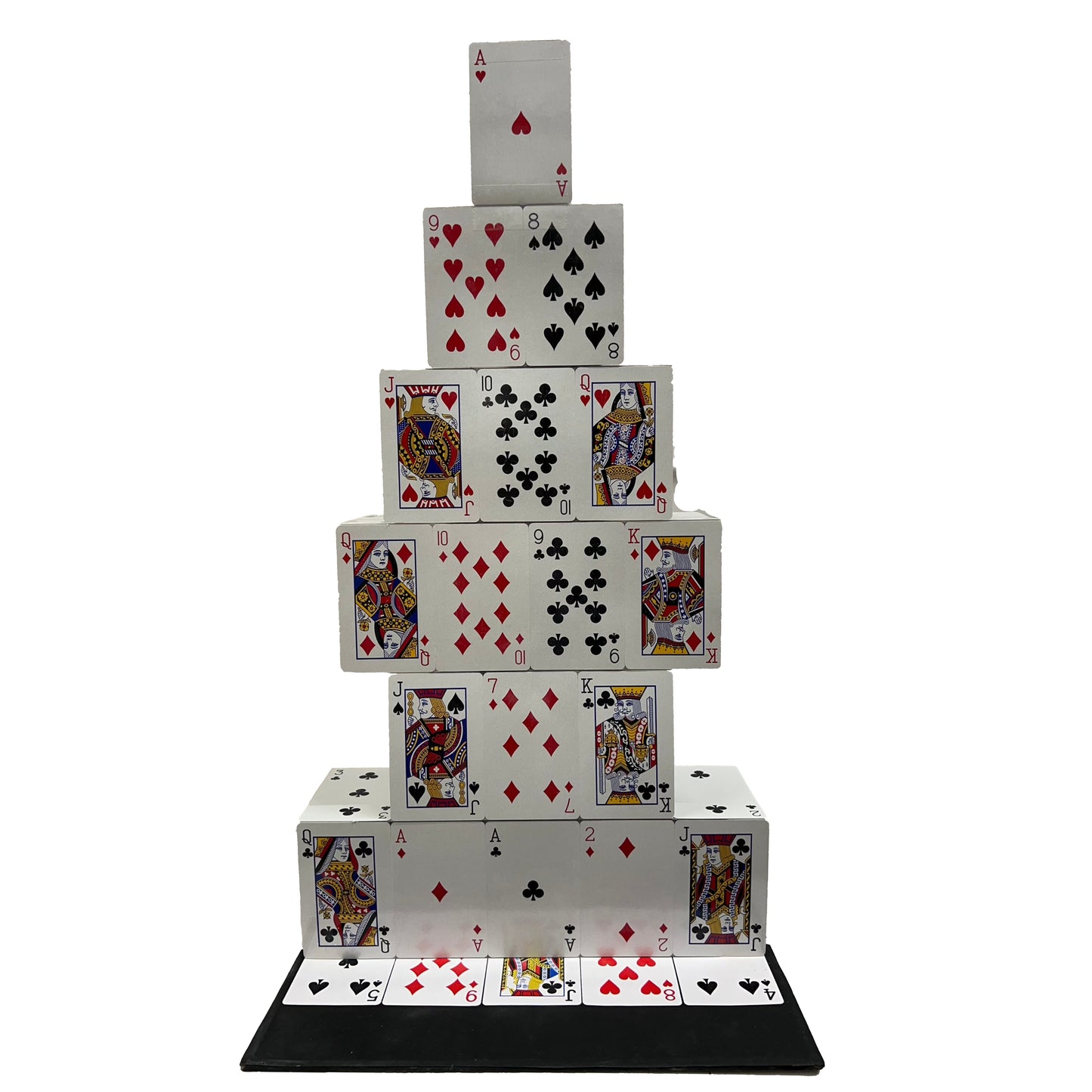 Stack of playing cards arranged in a pyramid shape on a white background